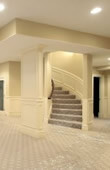 basement with winding stairs, recessed lights and carpet