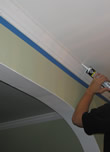 professional caulking molding next to painters tape