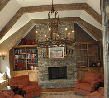 completed interior renovation with fireplace, hardwood flooring & exposed ceiling beams